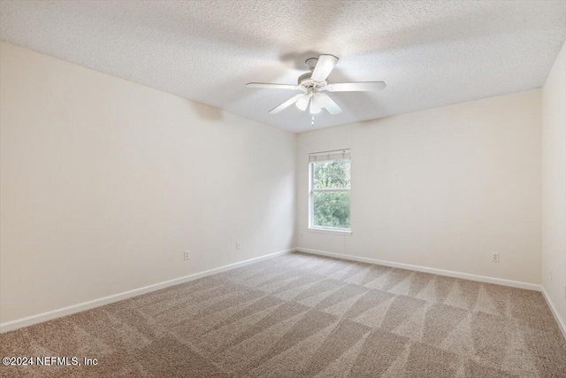 carpeted empty room with a textured ceiling and ceiling fan