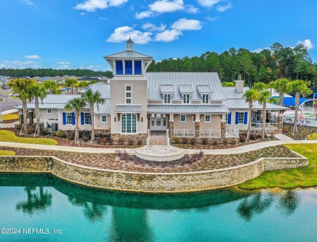 rear view of property with a water view