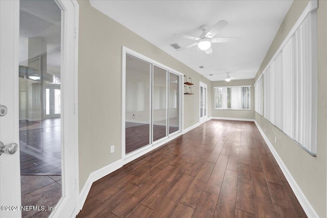 unfurnished sunroom with ceiling fan