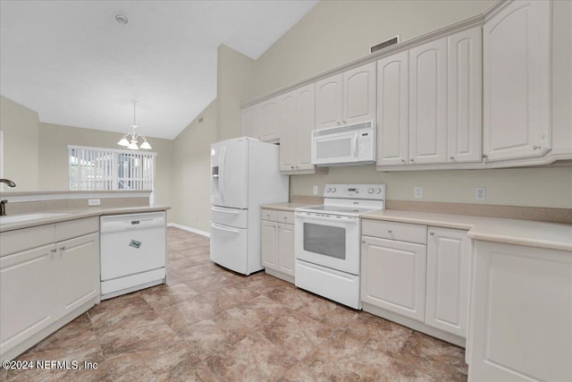 kitchen with white appliances, pendant lighting, white cabinets, a chandelier, and vaulted ceiling