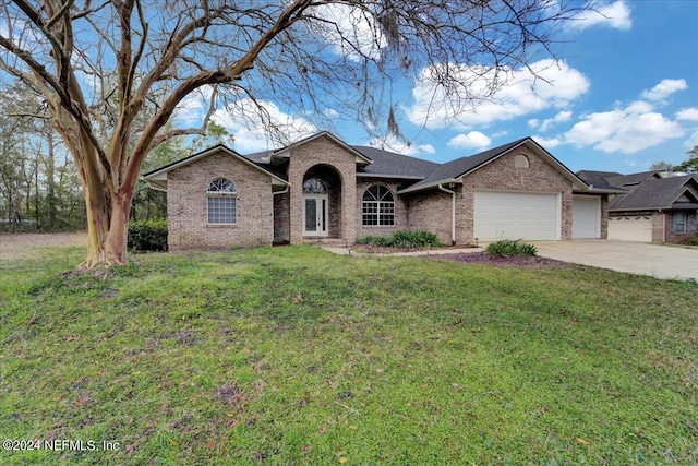 ranch-style house with a front yard and a garage