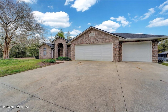 ranch-style house with a front lawn and a garage