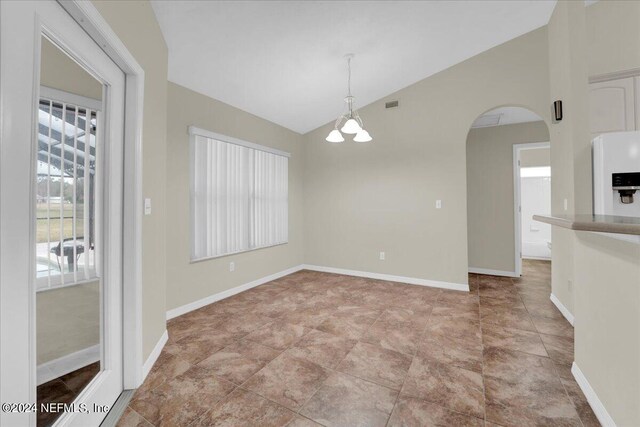 unfurnished room with an inviting chandelier, lofted ceiling, and light tile floors