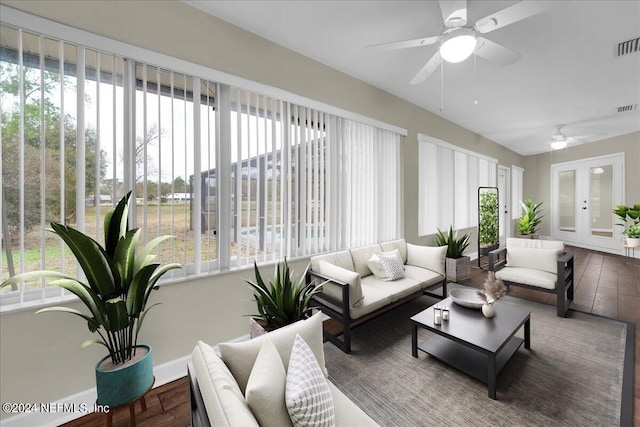 sunroom / solarium with french doors, ceiling fan, and a healthy amount of sunlight