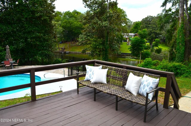 wooden deck featuring a water view