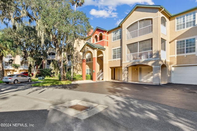 view of front of house featuring a balcony and a garage