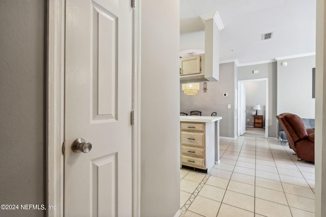 kitchen with crown molding and light tile patterned flooring