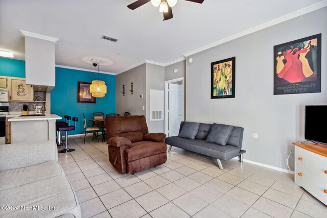 tiled living room featuring ornamental molding, sink, and ceiling fan