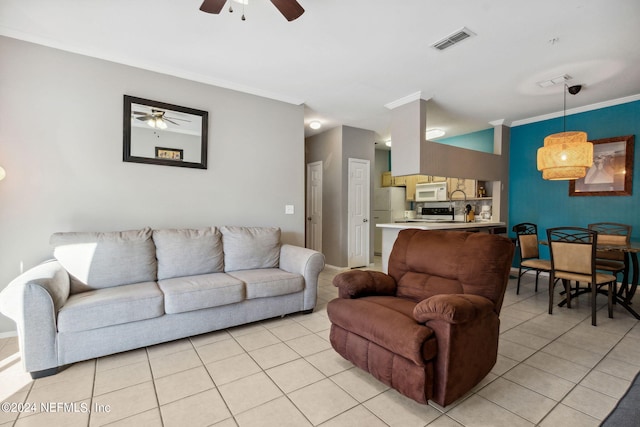 living room featuring ceiling fan, light tile patterned flooring, and ornamental molding