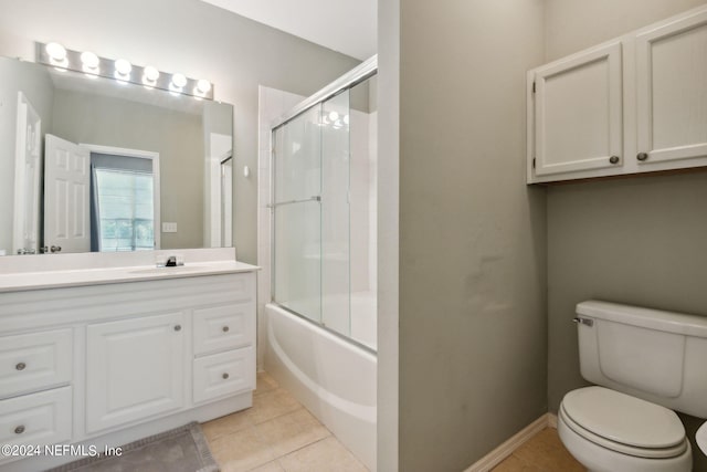 full bathroom with enclosed tub / shower combo, vanity, tile patterned flooring, and toilet