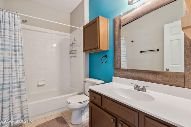 full bathroom with shower / tub combo, tile patterned flooring, vanity, and toilet