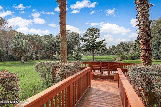 wooden terrace with a lawn