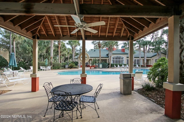 view of patio featuring ceiling fan and a community pool