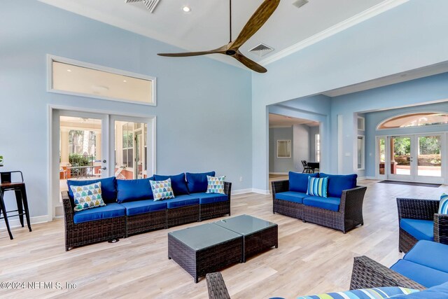 living room featuring french doors, light hardwood / wood-style flooring, plenty of natural light, and ceiling fan