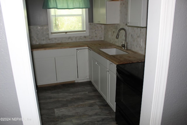 kitchen with wooden counters, sink, electric range, decorative backsplash, and white cabinetry