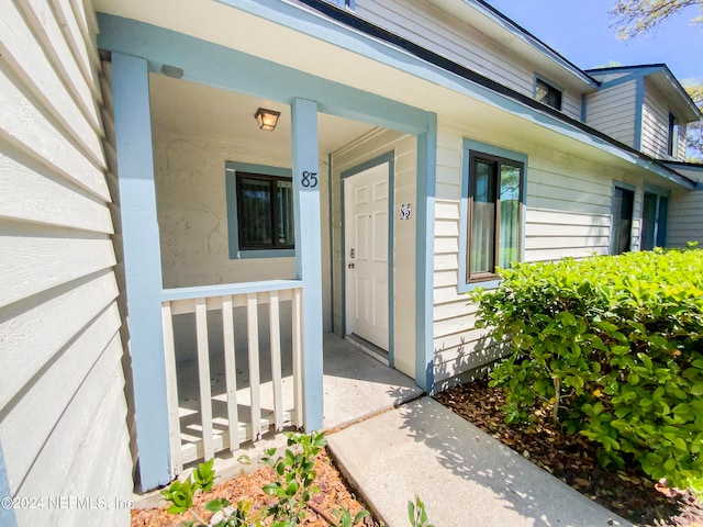 doorway to property featuring covered porch