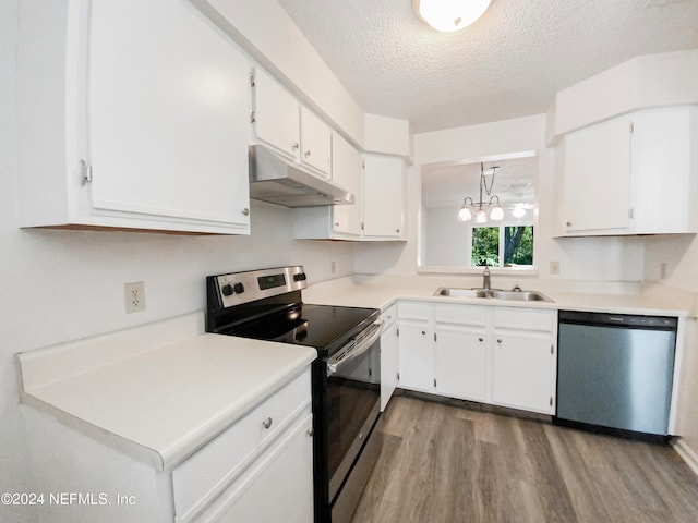 kitchen featuring white cabinetry, sink, light hardwood / wood-style flooring, stainless steel appliances, and a chandelier