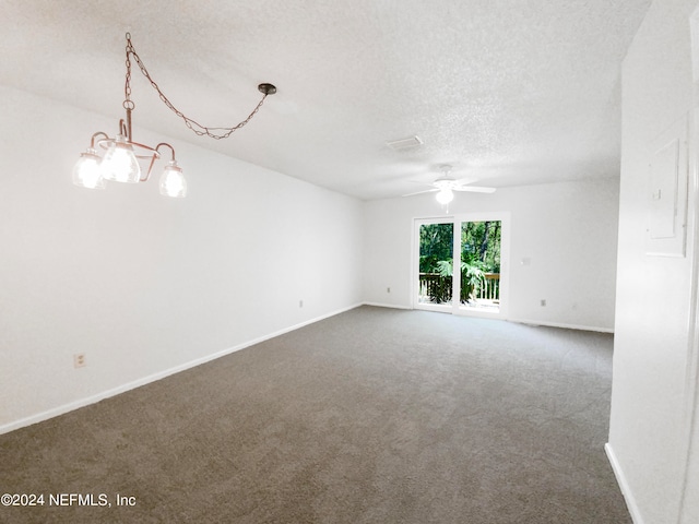 spare room with a textured ceiling, carpet floors, and ceiling fan with notable chandelier