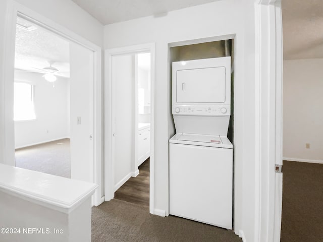 laundry room with dark carpet, stacked washer / dryer, and ceiling fan