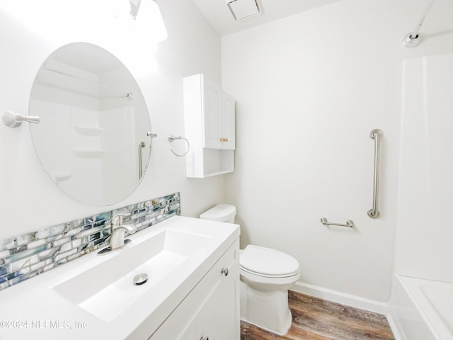 full bathroom with toilet, bathtub / shower combination, vanity, wood-type flooring, and backsplash