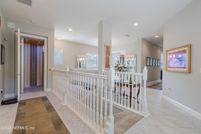 corridor featuring light tile patterned floors