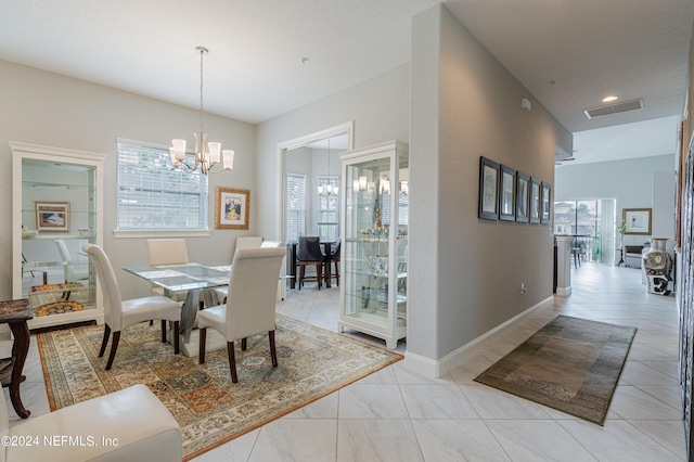 dining space featuring a notable chandelier