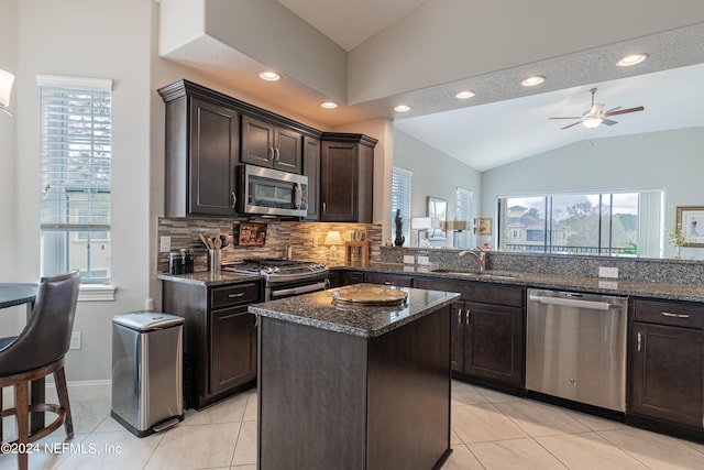 kitchen featuring lofted ceiling, sink, plenty of natural light, stainless steel appliances, and kitchen peninsula