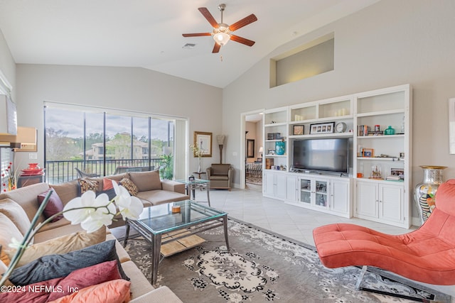 living room with light tile patterned flooring, ceiling fan, and vaulted ceiling