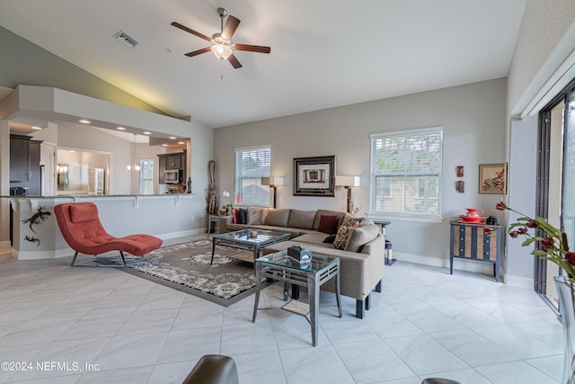 living room featuring light tile patterned floors, vaulted ceiling, and ceiling fan