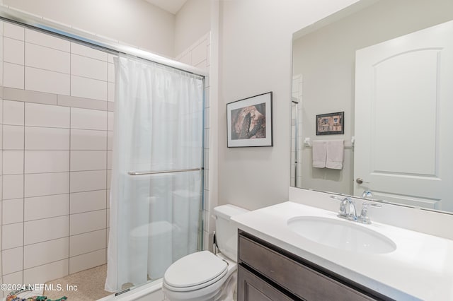 bathroom featuring vanity, toilet, and a shower with shower curtain