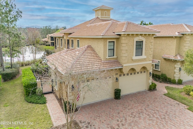 mediterranean / spanish home with a garage