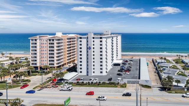 bird's eye view featuring a view of the beach and a water view