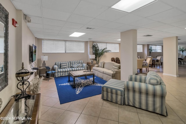 tiled living room featuring a drop ceiling