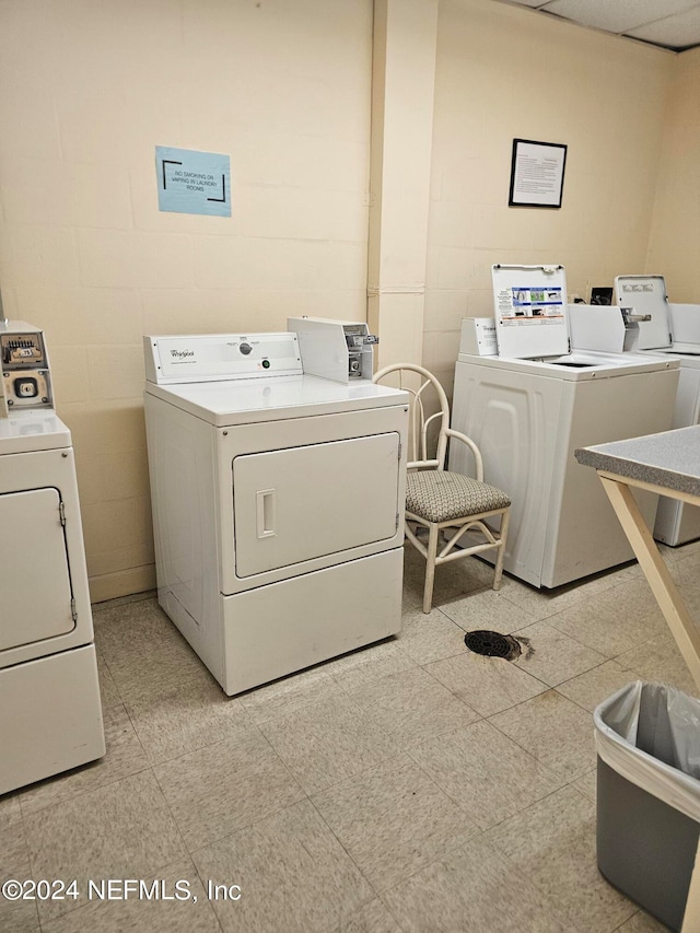 clothes washing area featuring separate washer and dryer