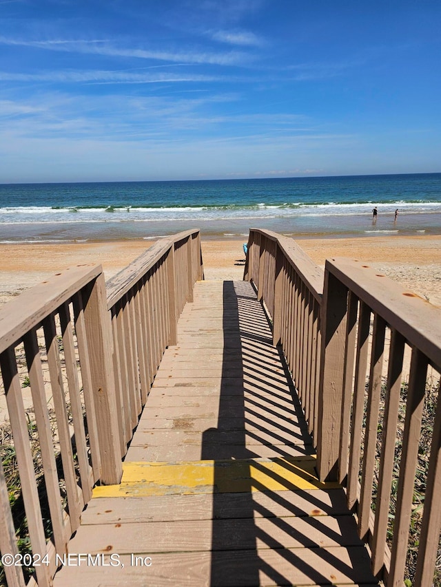 view of property's community featuring a view of the beach and a water view