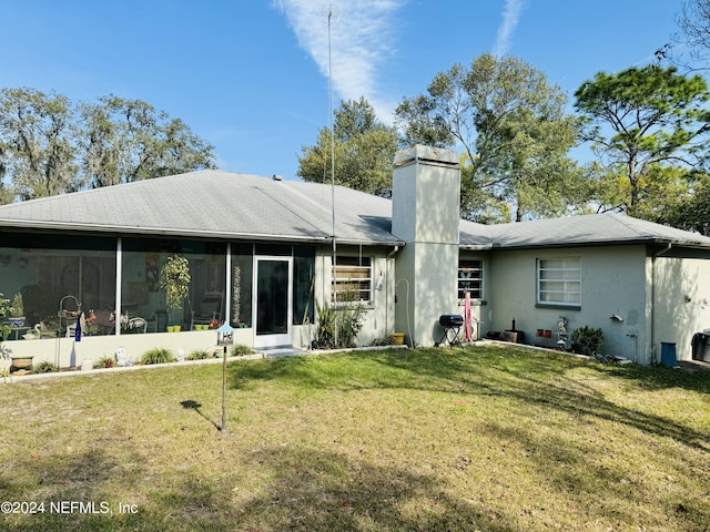 rear view of house with a lawn