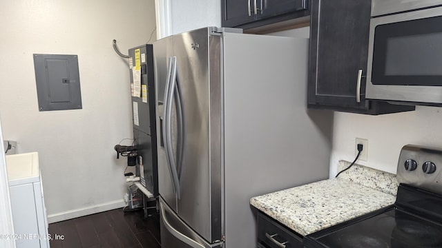 kitchen featuring light stone counters, appliances with stainless steel finishes, and dark hardwood / wood-style flooring