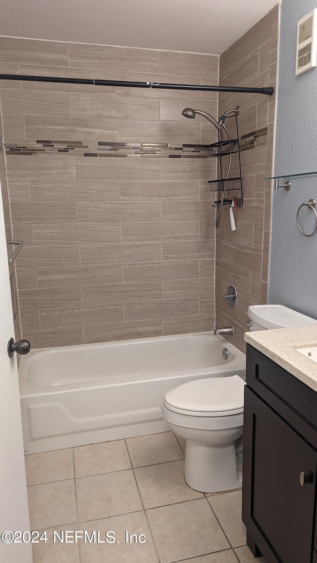 full bathroom featuring tiled shower / bath, toilet, tile flooring, and vanity