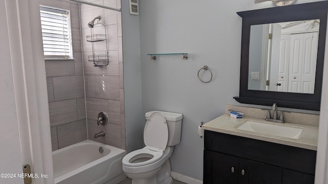 full bathroom with toilet, vanity, and tiled shower / bath