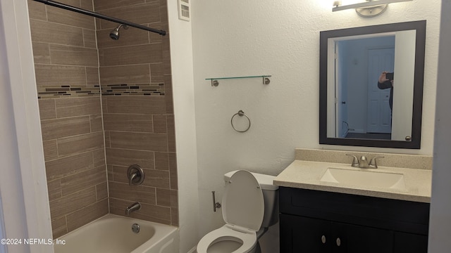 full bathroom with tiled shower / bath, toilet, and oversized vanity