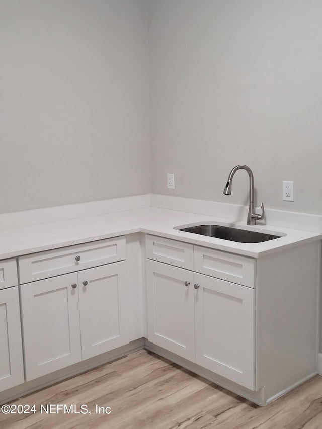 interior space with sink and light hardwood / wood-style flooring