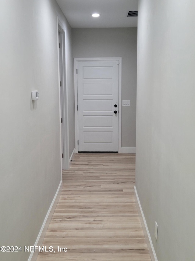 hall with light hardwood / wood-style floors