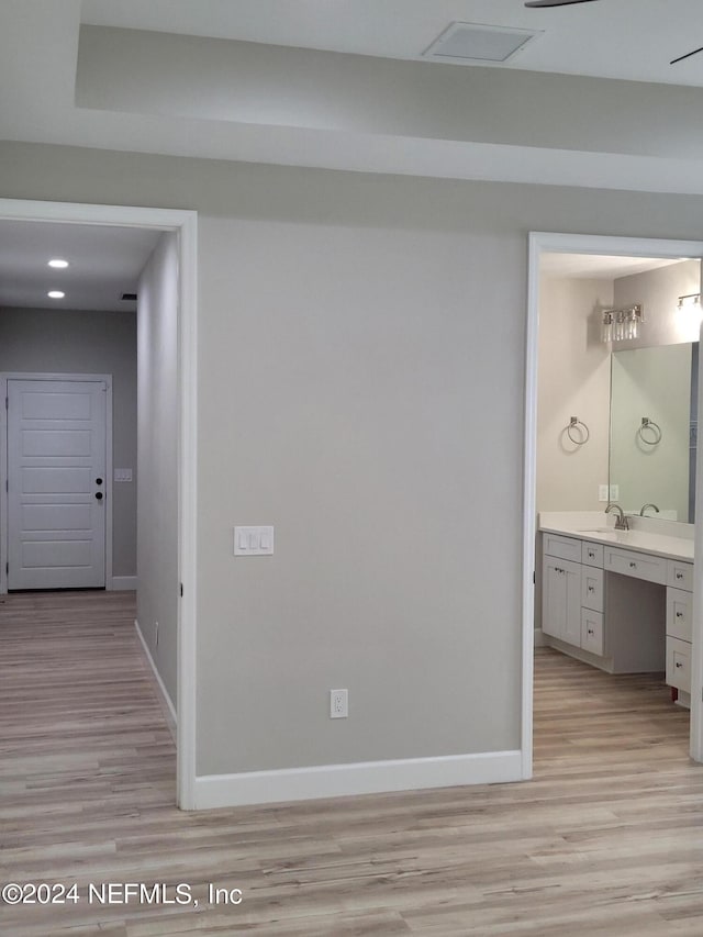 hall featuring light hardwood / wood-style floors and sink