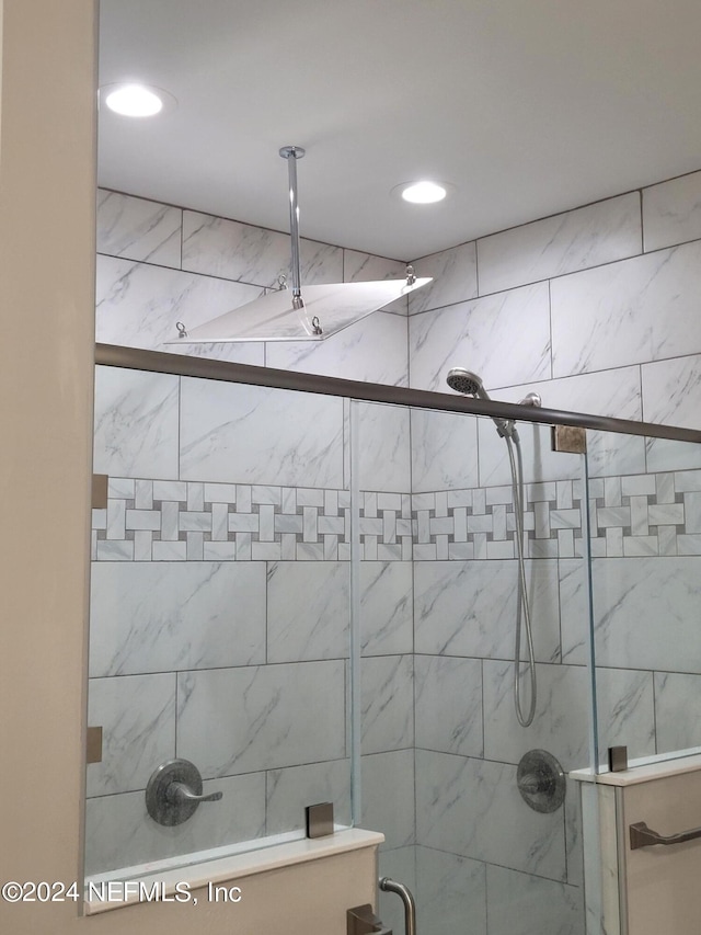 bathroom with a shower with shower door