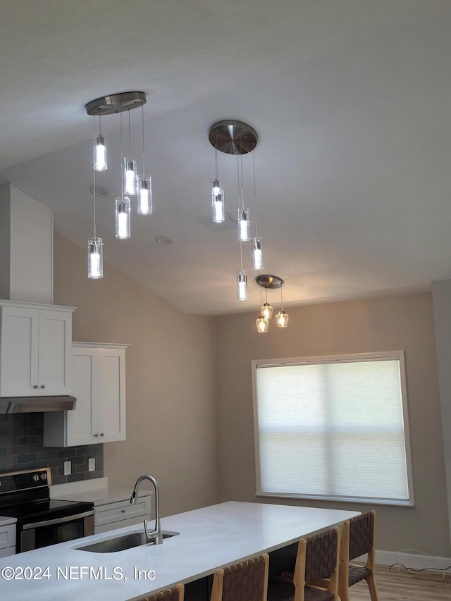 kitchen with decorative light fixtures, electric range, tasteful backsplash, white cabinets, and sink