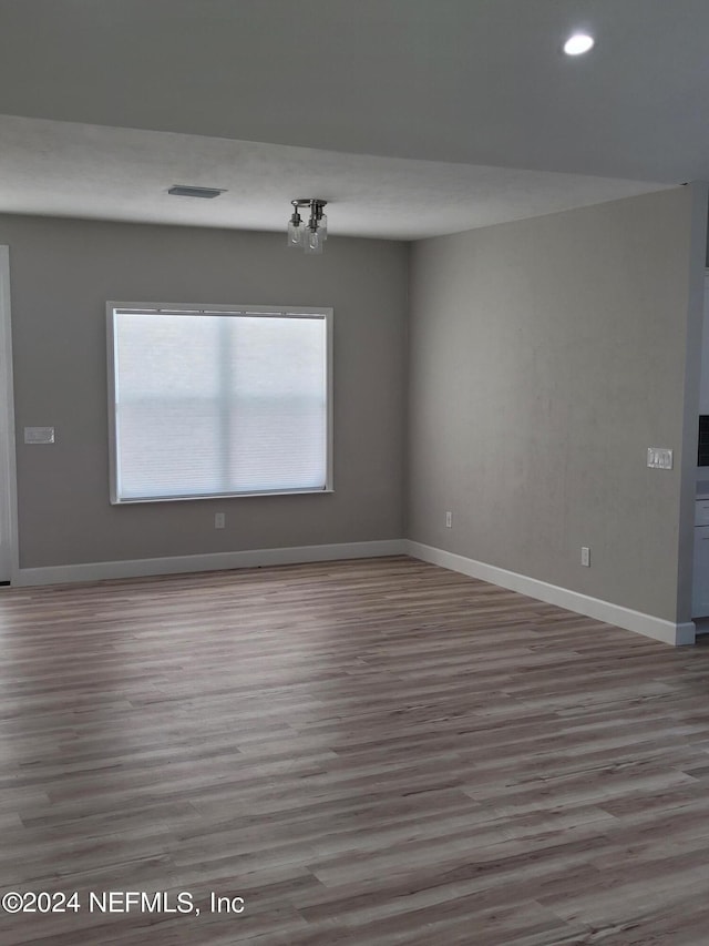 unfurnished room featuring hardwood / wood-style flooring