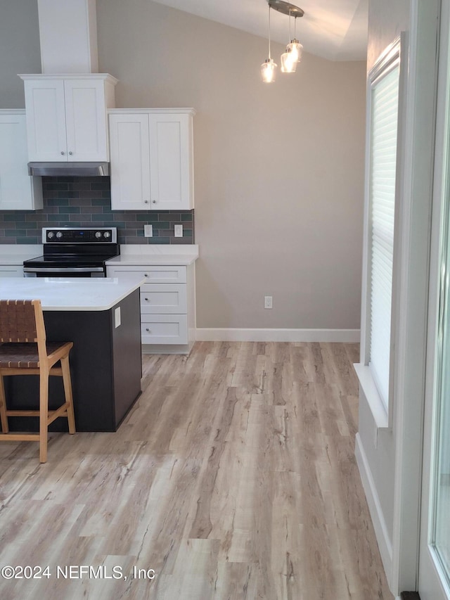 kitchen featuring electric stove, light wood-type flooring, white cabinets, vaulted ceiling, and tasteful backsplash