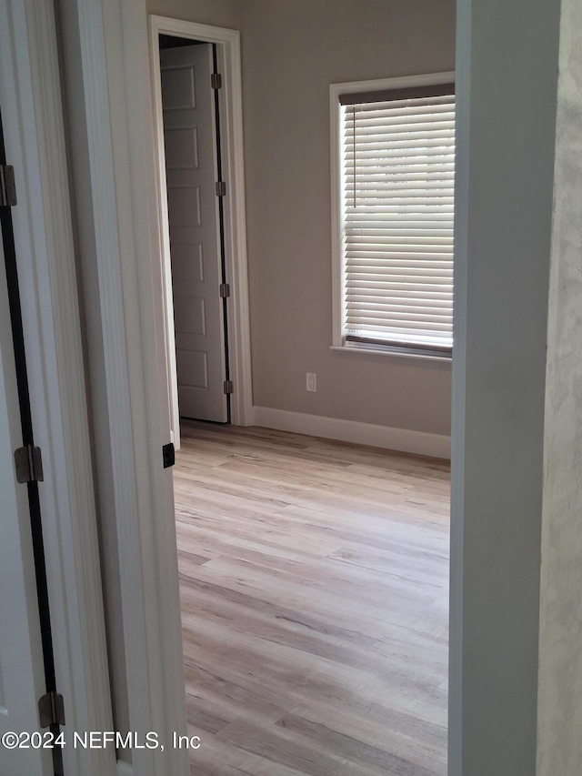 empty room with light hardwood / wood-style flooring