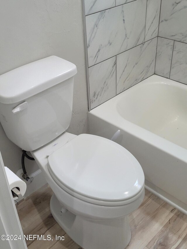 bathroom featuring hardwood / wood-style floors and toilet