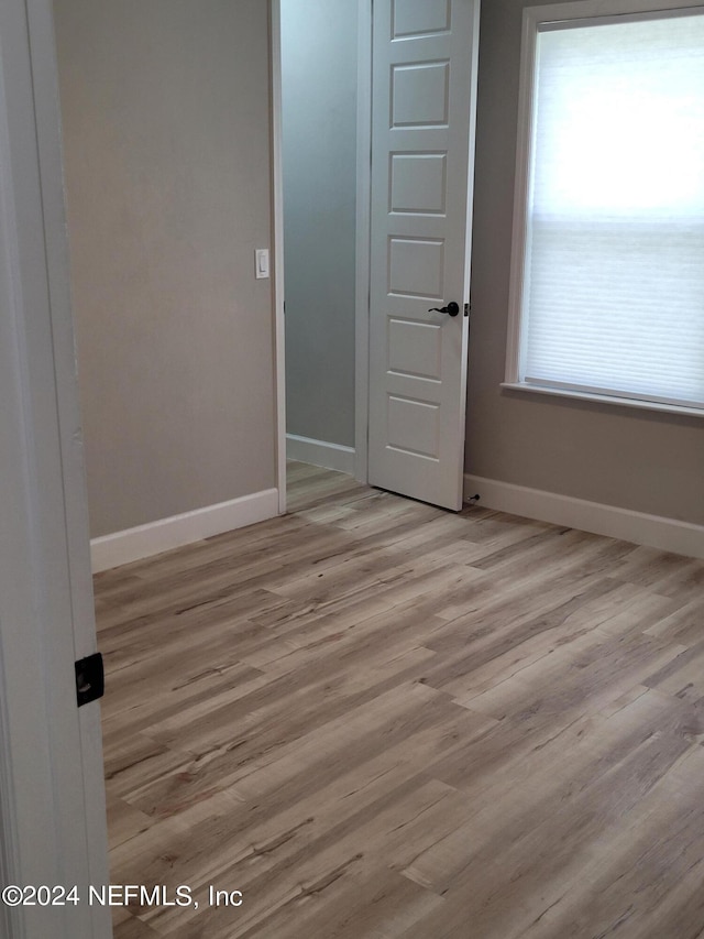 spare room with light hardwood / wood-style floors